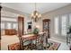 Formal dining room showcasing a chandelier, wood table with seating for six, and dark wood cabinets at 3614 Coventry Gardens Dr, Las Vegas, NV 89135