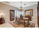 Elegant dining room featuring a decorative chandelier, an ornate mirror, and beautiful wooden furniture at 3614 Coventry Gardens Dr, Las Vegas, NV 89135