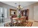 Traditional dining room featuring a chandelier, a dark wood dining table, and built-in hutch at 3614 Coventry Gardens Dr, Las Vegas, NV 89135