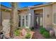 Charming entryway with a brick pathway, mature landscaping, and a decorative bench at 3614 Coventry Gardens Dr, Las Vegas, NV 89135