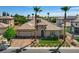This single-story home features professionally landscaped front yard with desert plants and tall palm trees at 3614 Coventry Gardens Dr, Las Vegas, NV 89135