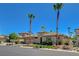 Beautiful landscaped home with palm trees and lush green lawn on a clear day at 3614 Coventry Gardens Dr, Las Vegas, NV 89135