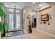 Inviting foyer with decorative glass entry doors, neutral walls and tile flooring at 3614 Coventry Gardens Dr, Las Vegas, NV 89135