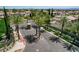 Gated entrance with well-maintained landscaping, palm trees, and manicured shrubbery at 3614 Coventry Gardens Dr, Las Vegas, NV 89135