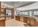 Gourmet kitchen with stainless steel appliances, granite countertops, tile floors, and dark wood cabinetry at 3614 Coventry Gardens Dr, Las Vegas, NV 89135
