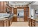 Modern kitchen featuring stainless steel appliances, granite countertops, custom cabinetry and tile flooring at 3614 Coventry Gardens Dr, Las Vegas, NV 89135