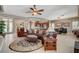 Open-concept living area with comfortable seating, a ceiling fan, and an elegant area rug at 3614 Coventry Gardens Dr, Las Vegas, NV 89135