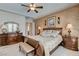 The main bedroom features a decorative wall treatment and tray ceilings at 3614 Coventry Gardens Dr, Las Vegas, NV 89135