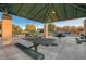 Covered picnic area with tables and benches offers a comfortable space for outdoor gatherings at 3614 Coventry Gardens Dr, Las Vegas, NV 89135
