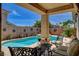 Inviting covered patio overlooking a pristine pool and spa at 3614 Coventry Gardens Dr, Las Vegas, NV 89135