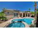 Backyard pool and spa area, featuring solar panels on the roof and a covered patio at 3614 Coventry Gardens Dr, Las Vegas, NV 89135