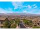 Expansive aerial view showcasing neighborhood, city skyline and picturesque mountains at 378 Gracious Way, Henderson, NV 89011