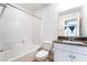 Bathroom featuring a shower-tub combo, white tile, and granite vanity at 378 Gracious Way, Henderson, NV 89011