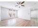 Bright, modern bedroom with wood-look flooring, ceiling fan, and neutral wall color at 378 Gracious Way, Henderson, NV 89011