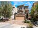 Charming two-story home with stone accents, a two-car garage, and landscaped front yard at 378 Gracious Way, Henderson, NV 89011