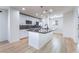 Modern kitchen featuring white cabinets, stainless steel appliances, and a granite-topped island with pendant lighting at 378 Gracious Way, Henderson, NV 89011