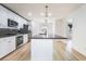 Modern kitchen featuring stainless steel appliances, granite counters, an island and hardwood floors at 378 Gracious Way, Henderson, NV 89011
