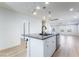 Open-concept kitchen and living area featuring an island with a sink and a view of the living room at 378 Gracious Way, Henderson, NV 89011