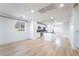 Bright, open-concept living room connected to a modern kitchen with island and hardwood floors at 378 Gracious Way, Henderson, NV 89011
