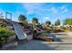 Slides built into the landscape provide a unique community playground experience on a sunny day at 378 Gracious Way, Henderson, NV 89011