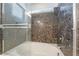 Close up of shower featuring decorative tile and glass door at 378 Gracious Way, Henderson, NV 89011