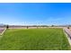 Large grassy backyard extending to a desert landscape with a mountain view at 3880 Rudek St, Pahrump, NV 89061