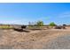 Spacious backyard featuring desert landscaping, trees, and a trampoline at 3880 Rudek St, Pahrump, NV 89061