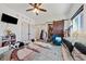 Bright bedroom featuring barn-door closet, ceiling fan, and playful decor at 3880 Rudek St, Pahrump, NV 89061