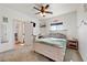 Neutral bedroom featuring a modern ceiling fan, natural light, and a full-sized bed at 3880 Rudek St, Pahrump, NV 89061