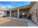 Long covered patio area with outdoor seating and cooking equipment at 3880 Rudek St, Pahrump, NV 89061