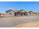 Charming single-story home featuring a covered porch, gravel yard, and a serene rural setting at 3880 Rudek St, Pahrump, NV 89061