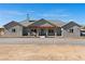 Charming single-story home with grey exterior, covered porch, and well-manicured gravel driveway at 3880 Rudek St, Pahrump, NV 89061
