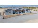 Charming single-story home with grey exterior, covered porch, and well-manicured gravel driveway at 3880 Rudek St, Pahrump, NV 89061