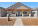 Inviting front porch with wood beams and decorative accents, creating a warm and welcoming entry at 3880 Rudek St, Pahrump, NV 89061
