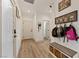 Entryway featuring white doors, light wood flooring, and a Gathering picture display, plus access to other rooms at 3880 Rudek St, Pahrump, NV 89061