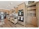 Bright kitchen showcasing stainless steel appliances, double ovens, ample storage, and modern fixtures at 3880 Rudek St, Pahrump, NV 89061