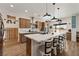 Bright kitchen featuring a large island with white countertops, a black sink, and pendant lighting at 3880 Rudek St, Pahrump, NV 89061