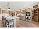 Spacious kitchen showcasing an island with wood accents, quartz countertops, and modern appliances at 3880 Rudek St, Pahrump, NV 89061