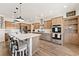 Large, stylish kitchen with wood cabinets, stainless steel appliances, and a spacious center island at 3880 Rudek St, Pahrump, NV 89061