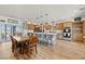 Expansive kitchen and dining area featuring wood floors, a center island, and stainless steel appliances at 3880 Rudek St, Pahrump, NV 89061
