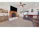 Cozy living room with fireplace and large TV, featuring a comfortable sectional sofa and neutral decor at 3880 Rudek St, Pahrump, NV 89061