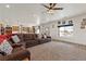 Spacious open-concept living area with an oversized sectional sofa, flowing into a modern kitchen at 3880 Rudek St, Pahrump, NV 89061