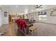 Open-concept living area with a large sectional sofa and views into the modern, eat-in kitchen at 3880 Rudek St, Pahrump, NV 89061