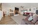 Bright living room with a brick fireplace, plush sofa, and open layout connecting to the kitchen at 3880 Rudek St, Pahrump, NV 89061