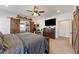 This is a main bedroom, with wooden barn door to a closet, flatscreen TV, and ceiling fan at 3880 Rudek St, Pahrump, NV 89061