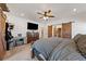 Main bedroom showcasing a ceiling fan, flatscreen TV, closet with sliding barn doors, and nice flooring at 3880 Rudek St, Pahrump, NV 89061