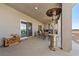 Large, covered patio with a propane heater, seating, and wood storage at 3880 Rudek St, Pahrump, NV 89061