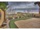 Charming backyard showcasing artificial turf, a patio, and decorative elements at 4017 Gliding Gulls Ave, North Las Vegas, NV 89084