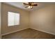 Cozy bedroom with a ceiling fan, window with blinds, and wood-look flooring at 4017 Gliding Gulls Ave, North Las Vegas, NV 89084