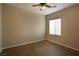 Bedroom featuring a ceiling fan, window with blinds, and wood-look flooring at 4017 Gliding Gulls Ave, North Las Vegas, NV 89084